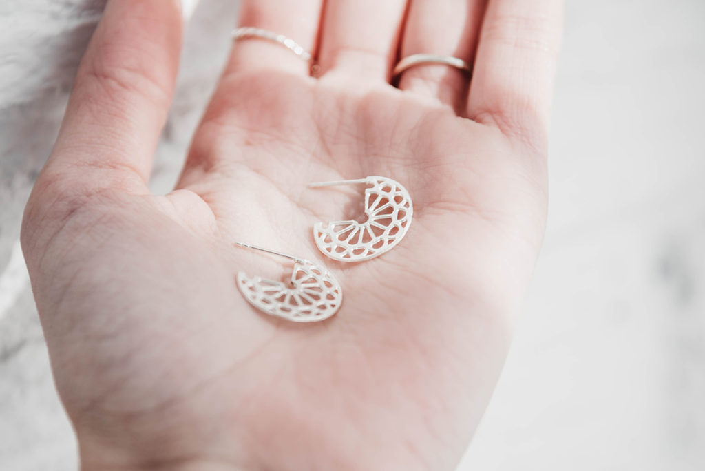 Emily Rowsell holding medallion cuff sterling silver earrings