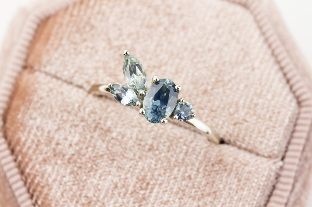 Custom designed asymmetrical montana sapphire engagement ring