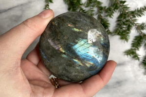 large labradorite palm stone held in hand