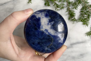 large sodalite palm stone held in hand