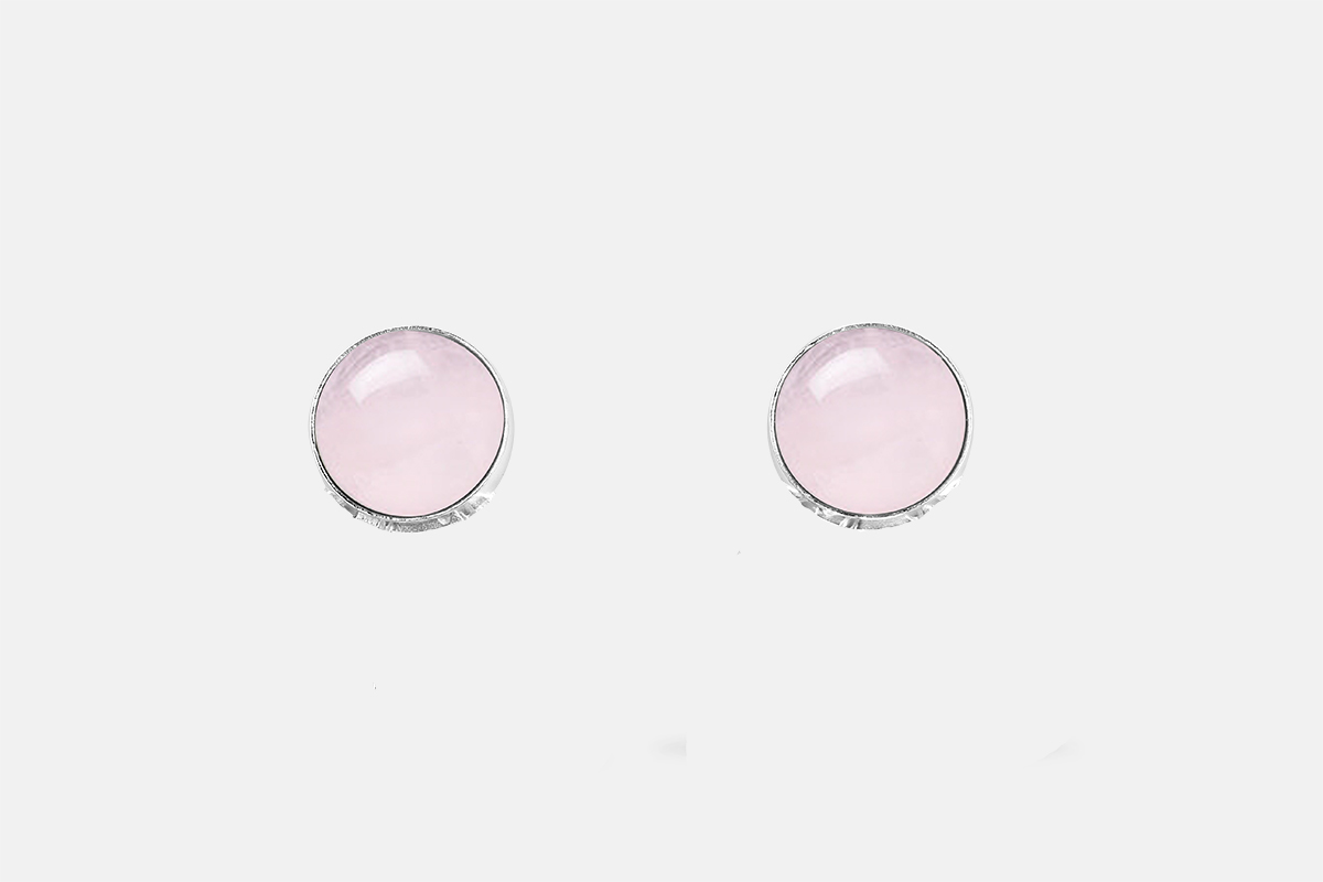 Sterling silver bezel settings with a smooth round pink rose quartz cabochon. Photo of the earrings on a white background.
