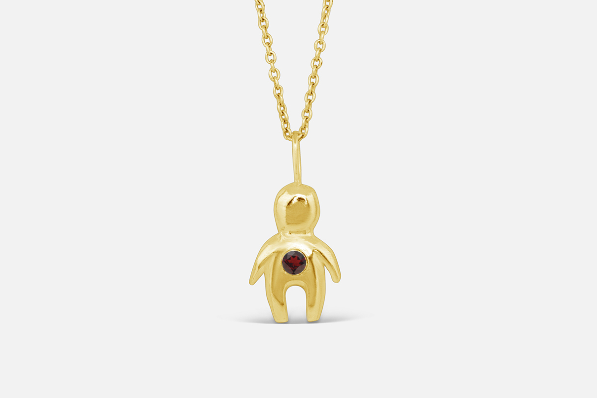 Gold totem necklace with January birthstone garnet.