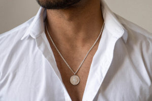 Large Astarstafur Icelandic Magic Pendant in Sterling Silver shown on model with white collared shirt.
