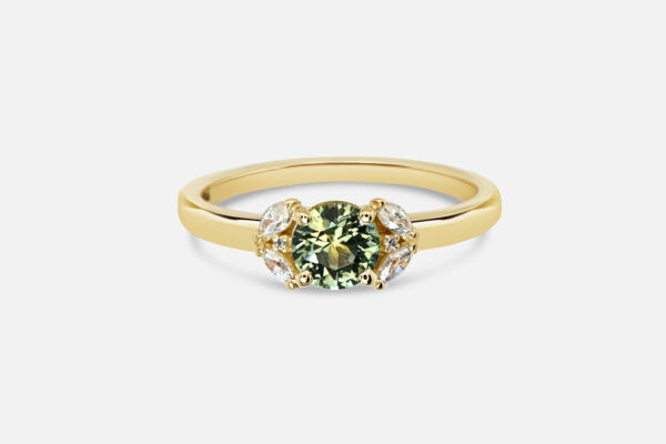 Custom alternative engagement ring in yellow gold with green sapphire