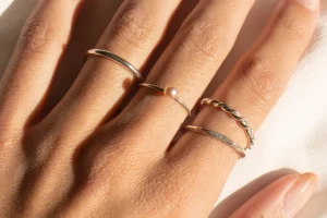 Woman's hand with various sterling silver stacking rings.