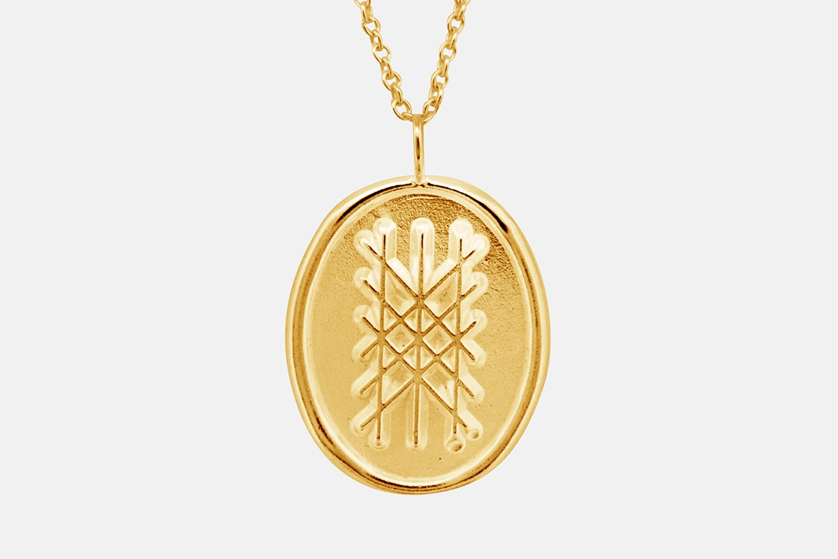 14k gold web of wyrd pendant.
