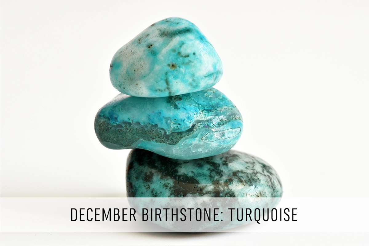 Three polished turquoise stones stacked one on top of the other on a white background with the text "December Birthstone: Turquoise"