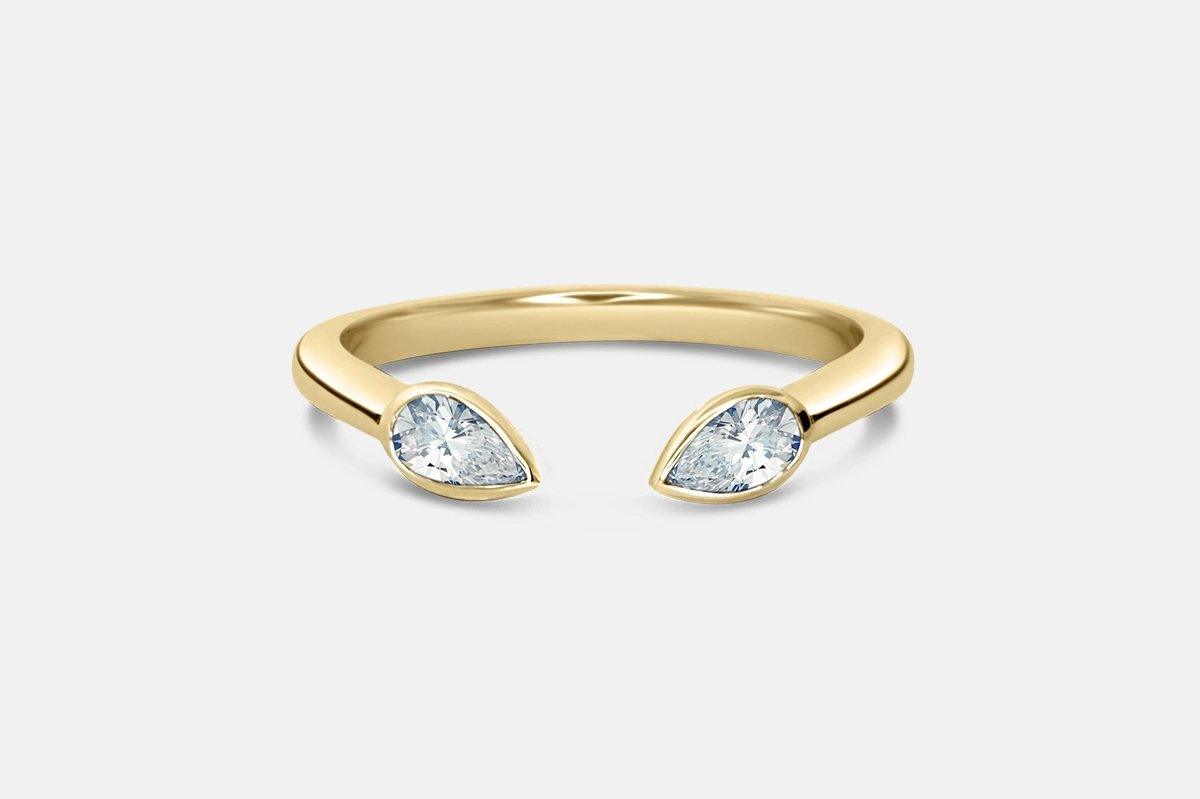 Open ring band with pear diamonds in gold.