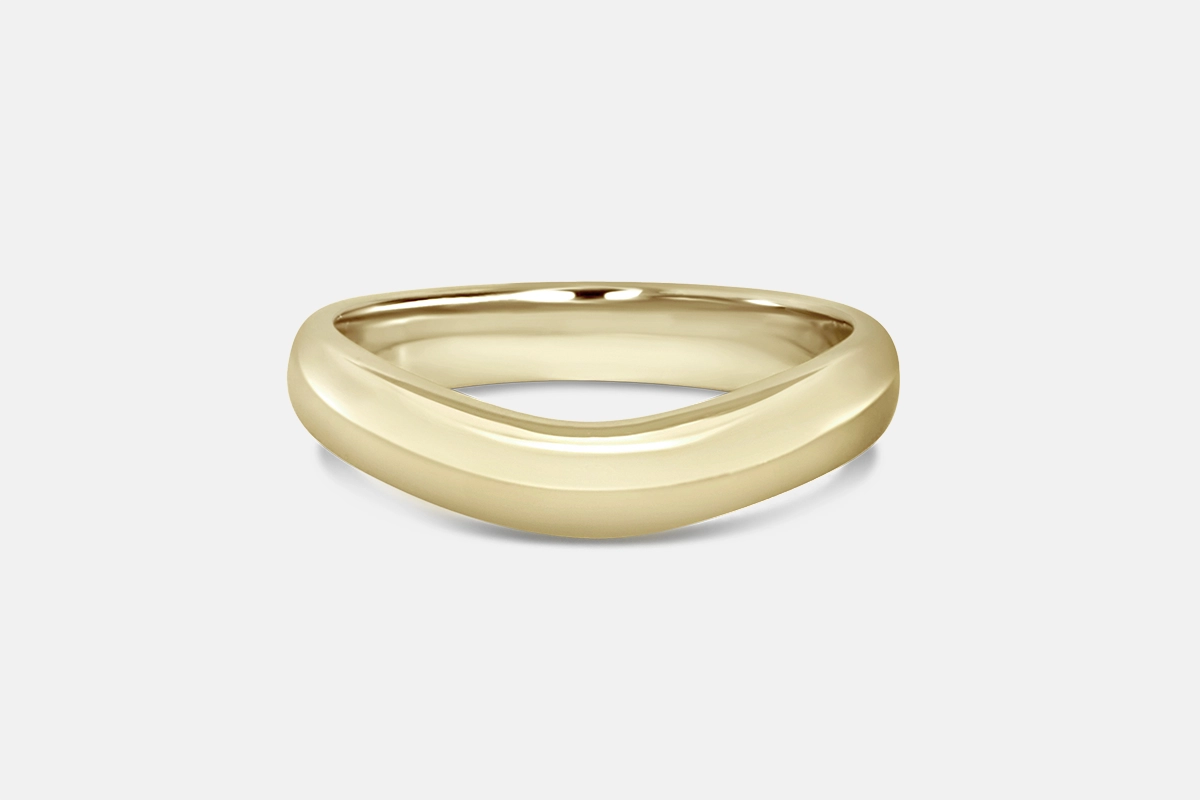 Contoured wedding band in yellow gold.