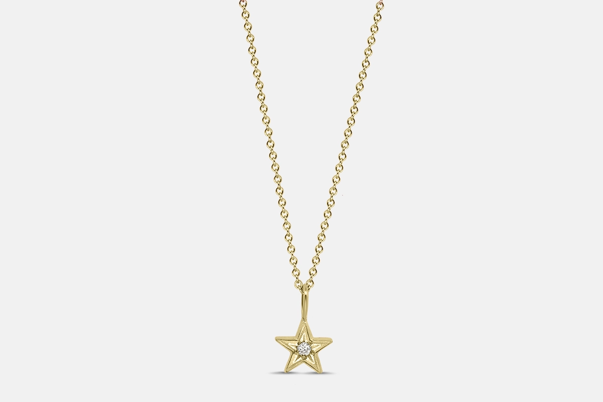 Lucky star charm pendant in yellow gold with diamond.