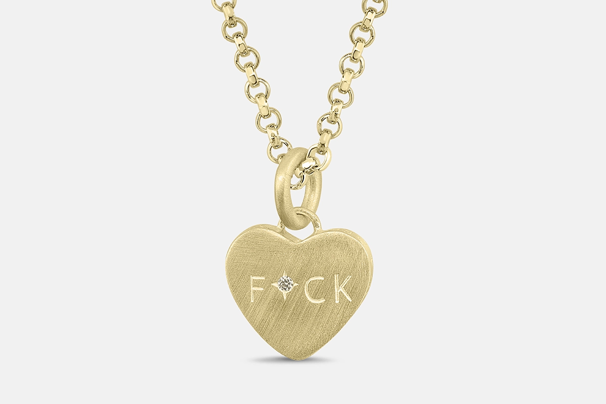 Gold conversation heart pendant with hand engraved FUCK and diamonds.