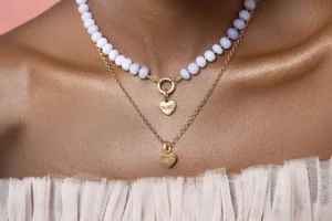 Layered solid gold conversation heart necklaces.