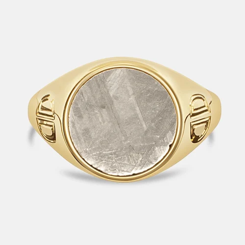 Yellow gold signet ring with round grey meteorite set into the top.